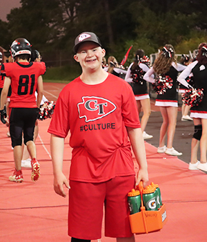 Happy student in red on the football field