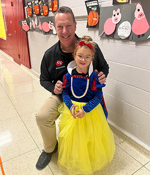 School admin with a cute girl dressed up as Cinderella