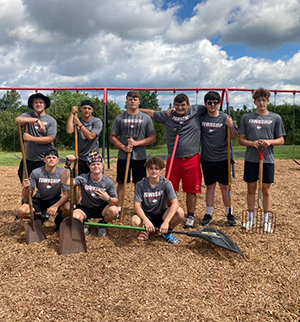 Group of high school boys with yard tools