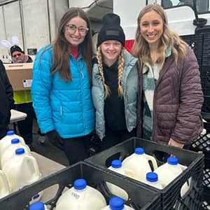 students loading milk in crates