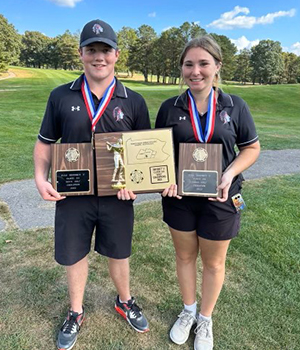 Two athletes holding awards outside