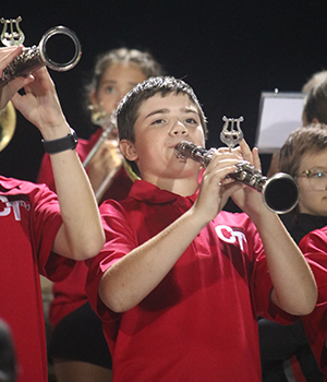 Elementary students playing horned instruments