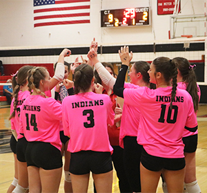 Girls volleyball team in a huddle